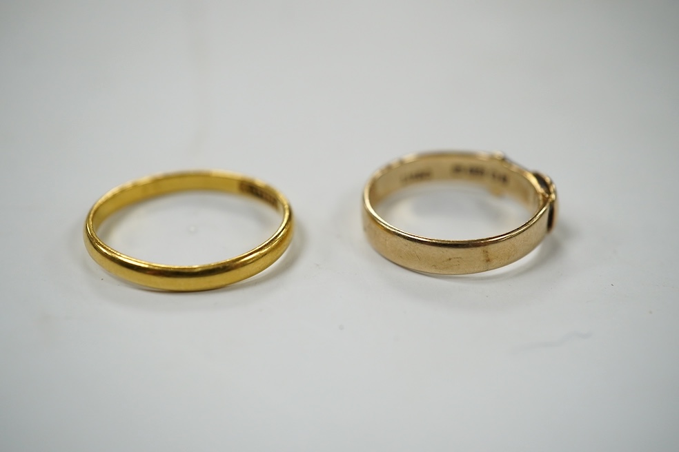 A modern 9ct gold buckle ring, 2.2 grams and a 22ct gold wedding band, 1.6 grams. Condition - poor